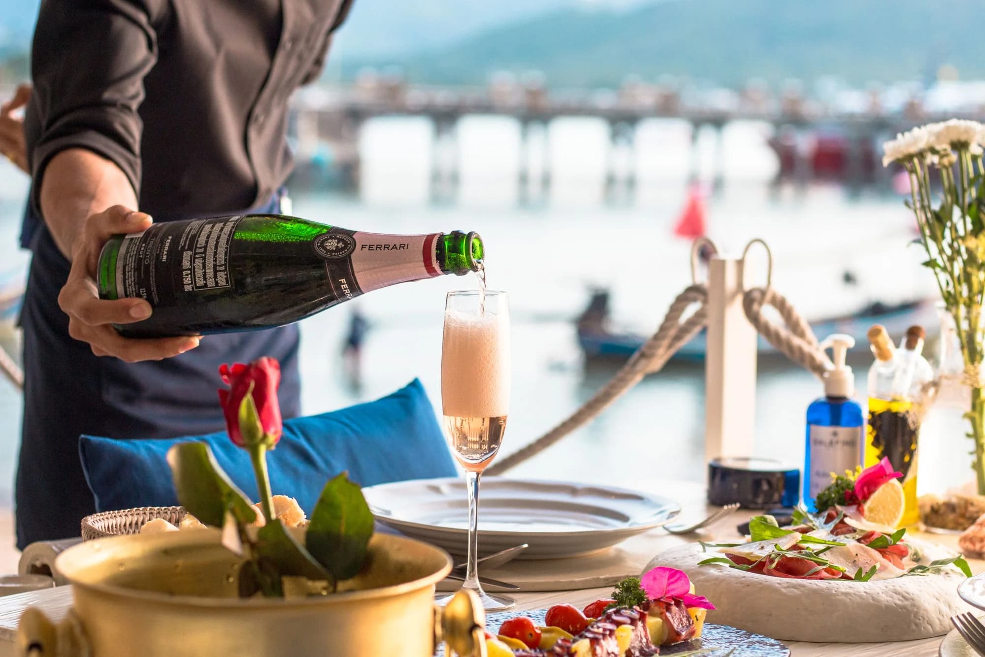 Champagne service at a table set by the sea